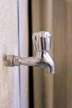 Close-Up of Silver Tap with blur background Stock Photos
