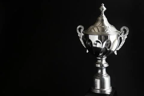 Close up of Silver trophy over black background. Winning awards with copy s.. Foto stock