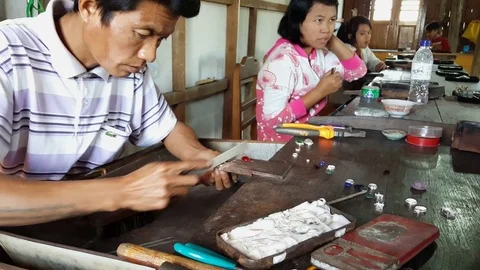 Close up of silversmith files silver, jewelry workshop, workers, Inle Lake Stockbeeldmateriaal 79839766