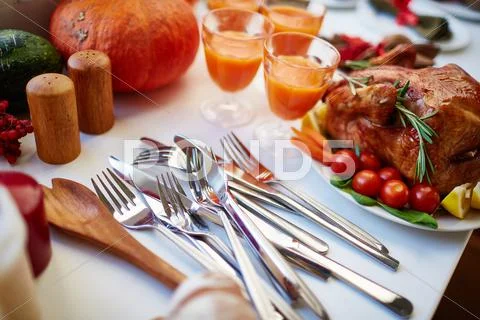 Close-up of silverware on thanksgiving table with roasted chicken Stock Photos