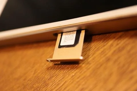 Close-up of a SIM card being inserted into a mobile smartphone tray highlig.. Stock Photos