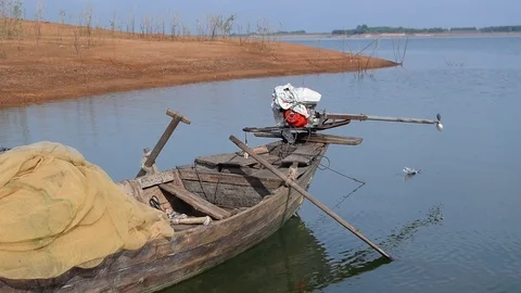 Close up simple boat anchor on river bank Stock Footage 90786181