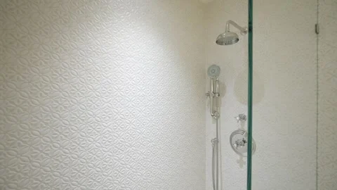 Close up of simple glass shower with white fluted tile on walls. Modern bathroom Stock Footage 242943701