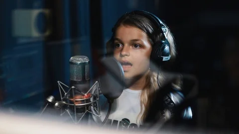 Close up singer child is training to make music in professional studio sound Stock Footage 98216632