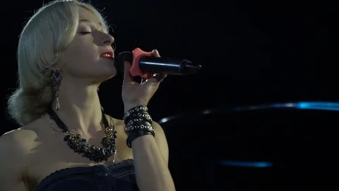 Close up of a singer with microphone in hand, singing on stage Stock Footage 111250382