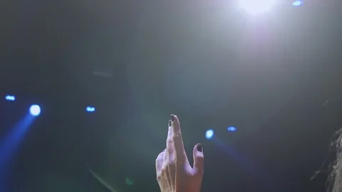 Close-up of the singer's hands with a microphone on stage under the light. Stock Footage 125319271