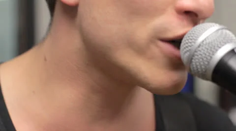 Close-up of a singer's mouth while he sings Stock Footage 22554506