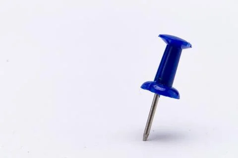Close-up of a Single Blue Push Pin on a White Background, Office Supply. Stock Photos