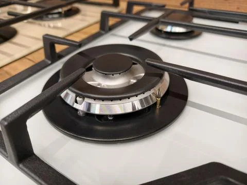 Close up of a single burner on a white built in gas stove displayed in a la.. Fotos de archivo