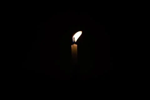 Close Up Single Burning, Bright White Paraffin Candle Light On Isolated Dark Stock-Fotos