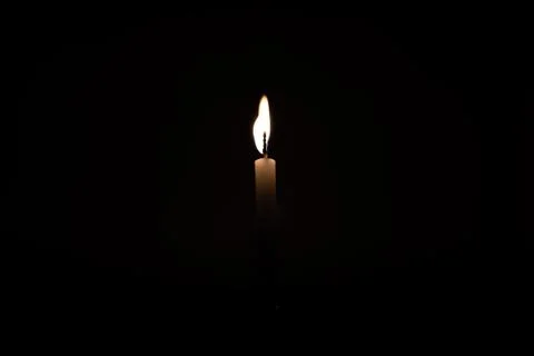 Close Up Single Burning, Bright White Paraffin Candle Light On Isolated Dark Stock-Fotos