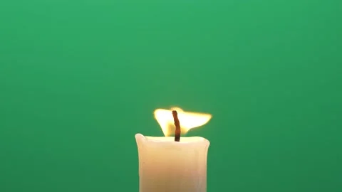 Close-up single candle flame isolated on chroma key green screen background Stock Footage 140785563