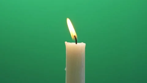 Close-up single candle flame isolated on chroma key green screen background Stock Footage 141974111
