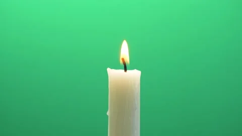 Close-up single candle flame isolated on chroma key green screen background Stock Footage 143233334