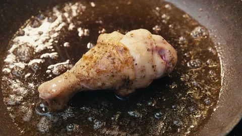 Close-up of single chicken leg fried in a pan. Stock Footage 152223777