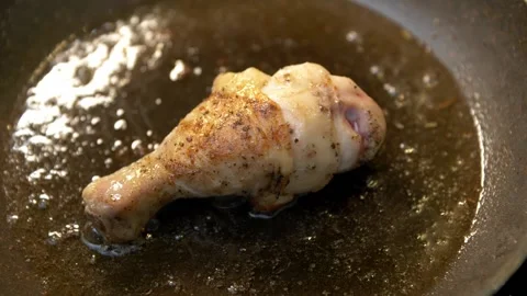 Close-up of single chicken leg fried in a pan. Stock Footage 152236886
