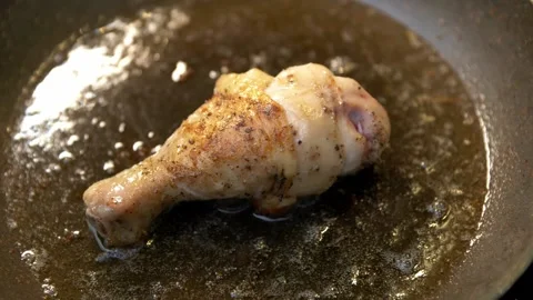 Close-up of single chicken leg fried in a pan. Stock Footage 152236888