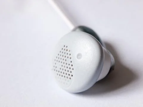 Close up of a single ear bud headphone white Stock Photos