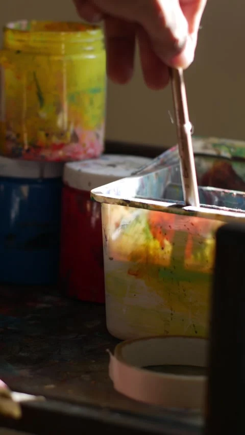Close-up of single flat paint brush with orange acrylic paint Stock Footage 336593475