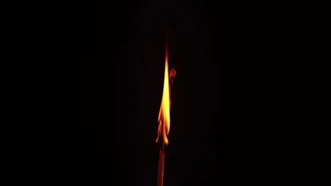 Close-Up of a Single Matchstick Burning in the Dark Stockbeeldmateriaal 338186365