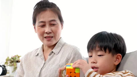 Close up of single mom using laptop for work from home and looking son sitt.. Stock Footage 249452280