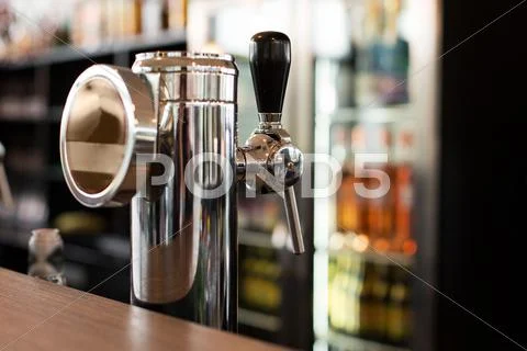 Close up of single tap chrome draft beer tower Stock Photos