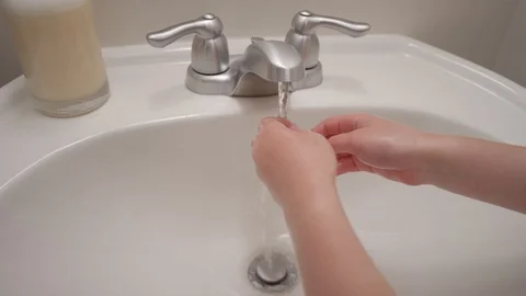 Close up of a sink and hands turning off water after rinsing. Stock Footage 128919251