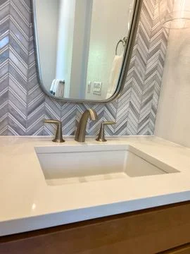 Close-up of sink with chevron tile backsplash Stock Photos