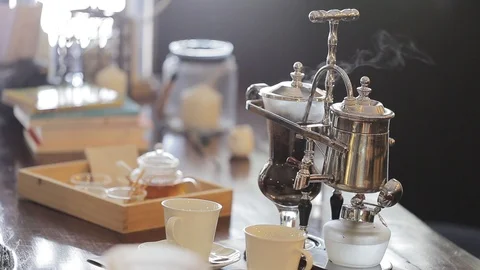 Close up of siphon vacuum, coffee cup and siphon vacuum coffee maker at shop. Stock Footage 94269856