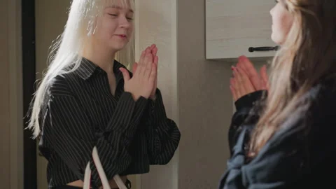 Close-up sisters clapping hands together in kitchen hallway Stock Footage 318120665