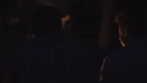 Close Up Sitting Around Campfire at Night Stock Footage 129457823