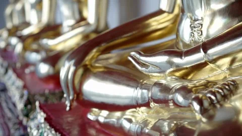 Close up of a sitting  buddhist gold statue Stock Footage 75535591