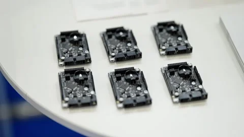 Close-up of six compact microcontroller development boards arranged neatly on a Stock Footage 325671475