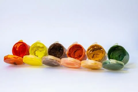 Close up of six opened plastic jars with dry gouache paint colors Stock Photos