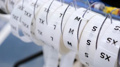 Close-up of size tag tapes size clothes proportions rolls in clothing store 動画素材 118709577