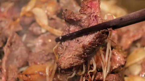Close-up of Sizzling Beef Stir-fry with Bean Sprouts and Onions in a Wok Stock Footage 333600210