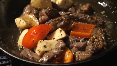 Close-up of Sizzling Beef Stir Fry with Bell Peppers and Potatoes in a Pan Stock Footage 337678806