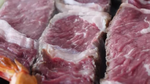 Close-up of Sizzling Grilled Ribeye Steaks on a Hot BBQ Grill Stock Footage 338210872
