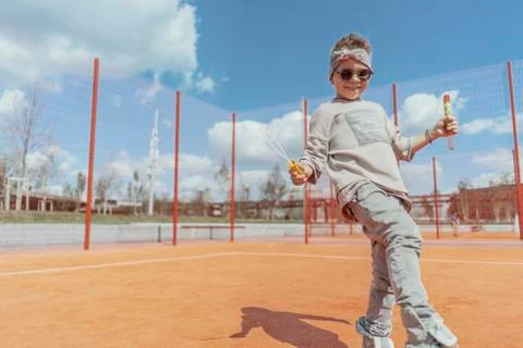 Close up of skateboading and making bubbles boy at colourful playground. Stock Photos