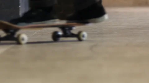 Close up of skateboarder riding by Stock Footage 41606759