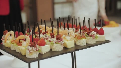 Close-up of skewer canapes on the buffet table in the wedding. Tasty food in a Stock Footage 308396226