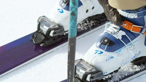 Close up of skier adjusting and wearing ski boots on snow in slow motion Stock Footage 124206084