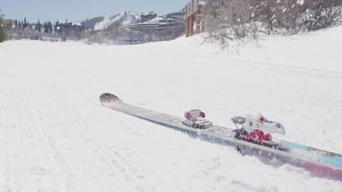 Close up of skies dropping to the ground on snow packed ski run in Utah Stock Footage 203993889