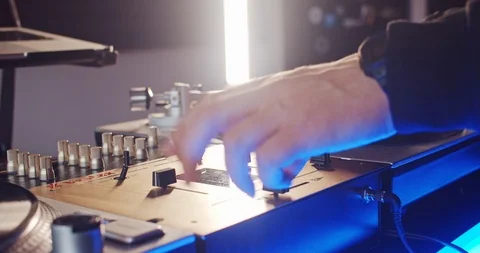 Close-up skilful hands of DJ turning knobs twisting levers on vinyl mixer. DJ 스톡 동영상 114346853