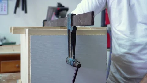Close up on skilled carpenter busy at work assembling a wooden crate in Stock Footage 220758567