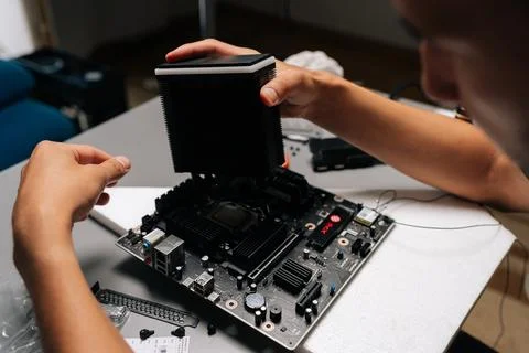 Close-up of skilled computer technician installing CPU cooler onto motherboard Stock Photos