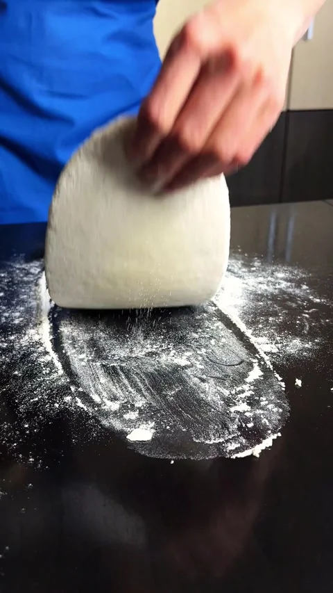 Close up of skilled hands shaping rustic sourdough. Organic ingredients Stock Footage 314433195