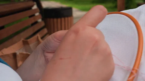 Close Up of Skilled Person Embroidering Pattern with Needle and Thread Stock Footage 322668096