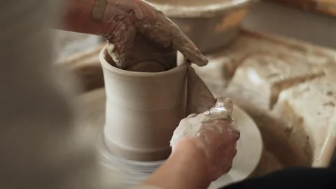 Close-up of skilled potter's hands finalizing the shape of a clay piece wit.. Stock Footage 272839629