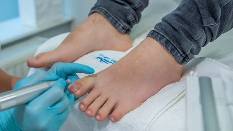 Close up of skilled professional using electric nail drill pen during Video stock 122373241